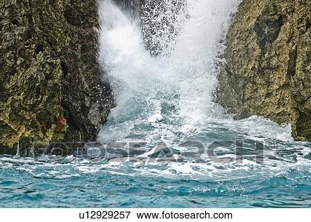 Stock Photo - Wave Splashing Against Rocks. Fotosearch