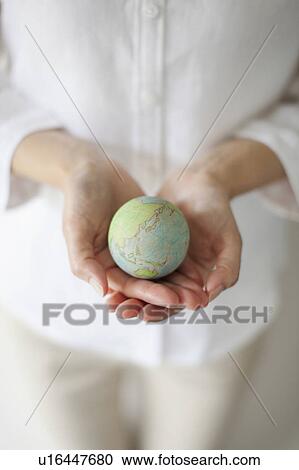 Stock Image - Woman Holding Globe. Fotosearch