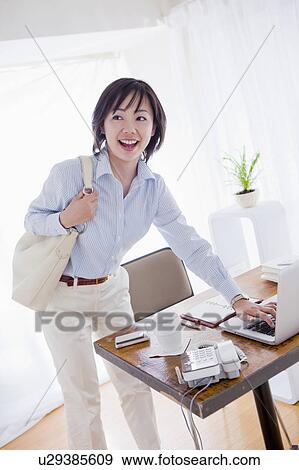Stock Photo - Woman Leaving her Desk. Fotosearch