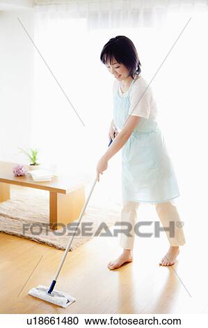 Stock Image - Woman Mopping Floors. Fotosearch