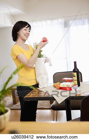 Woman Unpacking Grocery Bag View Large Photo Image Stock Image - Woman Unpacking Grocery Bag. Fotosearch