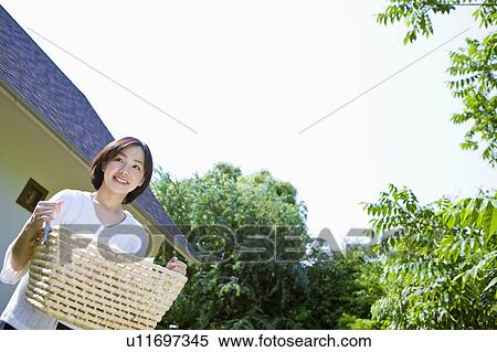 Woman Walking With Laundry Basket in Park View Large Photo Image Stock Photography - Woman Walking With Laundry Basket in Park. Fotosearch