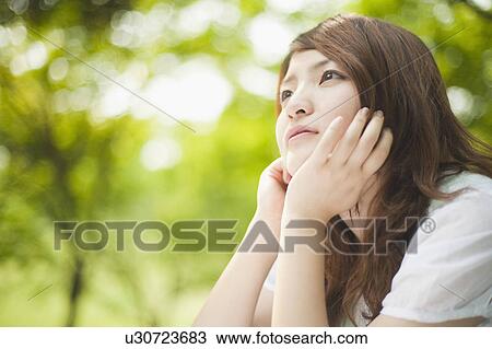 Woman with hands on chin View Large Photo Image Stock Image - Woman with hands on chin. Fotosearch
