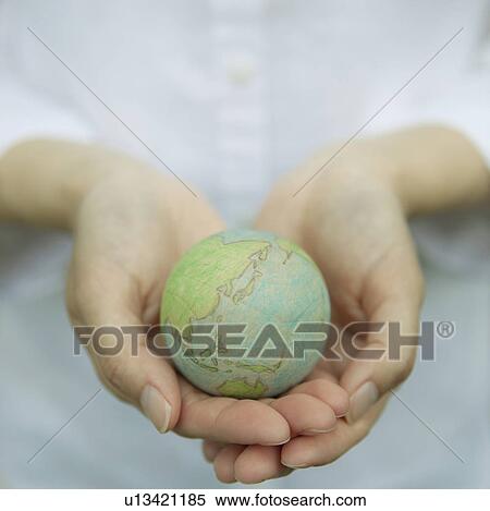 Stock Photography - Wooden Globe in Cupped Hands. Fotosearch