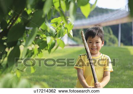 Stock Image - Young Boy With a Stick. Fotosearch