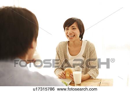 Stock Photograph - Young Couple Having Breakfast. Fotosearch
