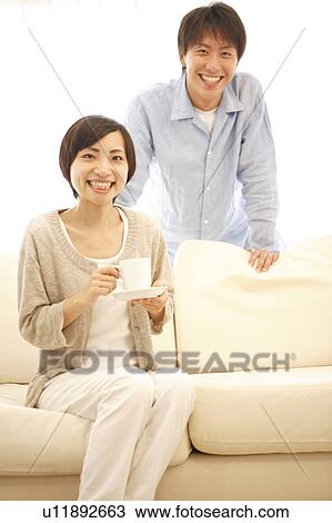 Young Couple Smiling at Sofa View Large Photo Image Stock Image - Young Couple Smiling at Sofa. Fotosearch