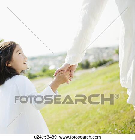 Young Girl Holding Mother's Hand and Walking in Field View Large Photo Image Stock Photo - Young Girl Holding Mother's Hand and Walking in Field. Fotosearch