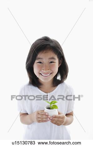 Stock Image - Young Girl Holding Potted Sprout. Fotosearch