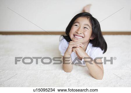 Young Girl Lying on her Front and Thinking View Large Photo Image Picture - Young Girl Lying on her Front and Thinking. Fotosearch