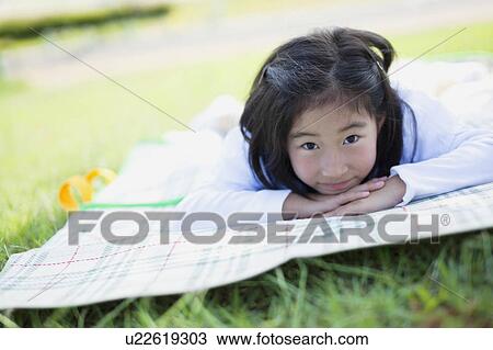 Young Girl Lying on Towel Outdoors View Large Photo Image Stock Image - Young Girl Lying on Towel Outdoors. Fotosearch