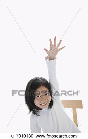 Stock Image - Young Girl Raising her Hand. Fotosearch