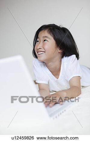 Young Girl Using Laptop and Looking up View Large Photo Image Stock Photograph - Young Girl Using Laptop and Looking up. Fotosearch