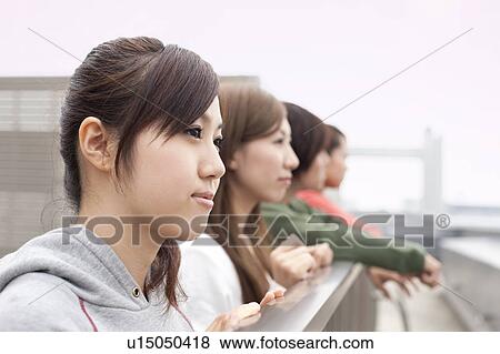 Young man and women on rooftop, Japan View Large Photo Image Stock Photo - Young man and women on rooftop, Japan. Fotosearch