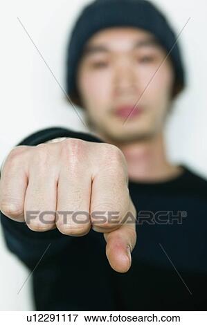 Stock Photo - Young Man Holding up Fist. Fotosearch