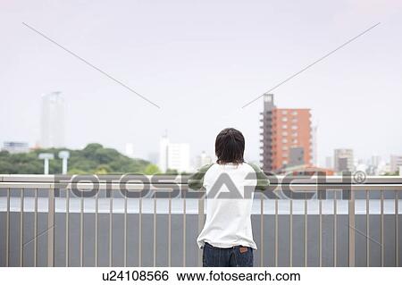 Young man on a rooftop, rear view, Japan View Large Photo Image Stock Photograph - Young man on a rooftop, rear view, Japan. Fotosearch