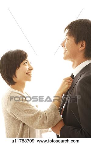 Young Woman Adjusting Her Husband's Tie View Large Photo Image Stock Photo - Young Woman Adjusting Her Husband's Tie. Fotosearch