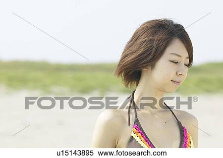 Young woman at beach, differential focus View Large Photo Image Stock Photography - Young woman at beach, differential focus. Fotosearch