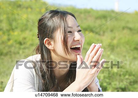 Stock Photo - Young Woman Clapping Hands, Smiling. Fotosearch