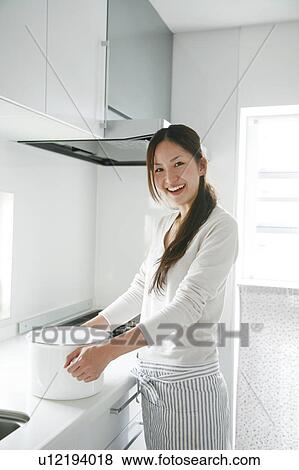 Young Woman Holding Deep Pan in Kitchen View Large Photo Image Stock Photo - Young Woman Holding Deep Pan in Kitchen. Fotosearch