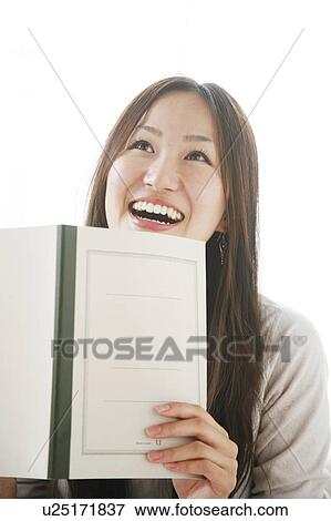 Young Woman Holding Notebook, Laughing View Large Photo Image Stock Photo - Young Woman Holding Notebook, Laughing. Fotosearch