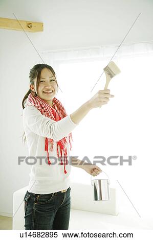 Young Woman Holding Painting Brush and Can of Paint View Large Photo Image Stock Photography - Young Woman Holding Painting Brush and Can of Paint. Fotosearch