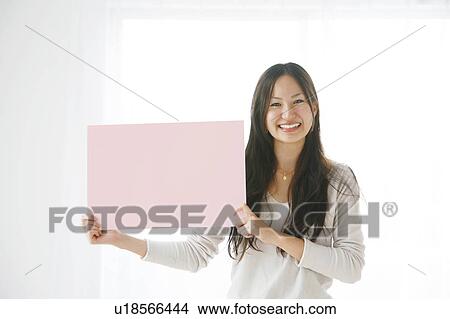 Picture - Young Woman Holding Pink Rectangle. Fotosearch
