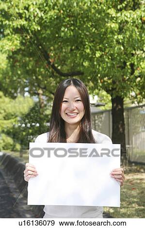 Stock Photo - Young Woman Holding White Board. Fotosearch