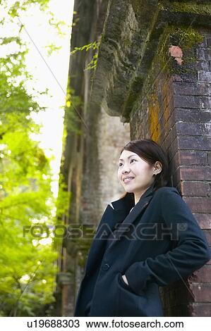 Young Woman Leaning on Brick Wall View Large Photo Image Stock Image - Young Woman Leaning on Brick Wall. Fotosearch