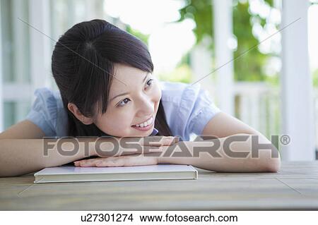 Young Woman Leaning on Notebooks View Large Photo Image Picture - Young Woman Leaning on Notebooks. Fotosearch