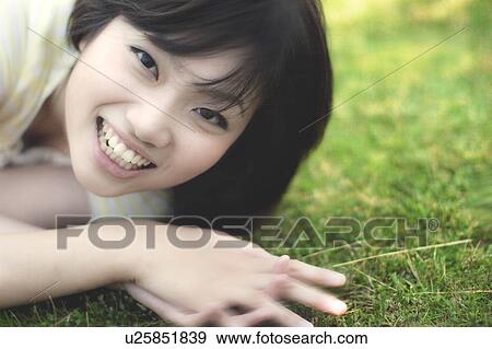 Young woman looking at camera View Large Photo Image Stock Photo - Young woman looking at camera. Fotosearch