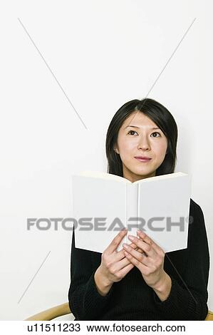 Young Woman Looking up From Book View Large Photo Image Stock Image - Young Woman Looking up From Book. Fotosearch