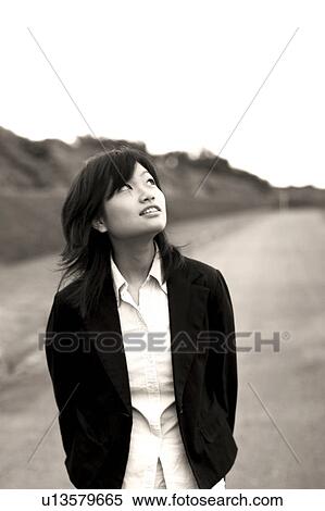 Young woman looking up View Large Photo Image Stock Photography - Young woman looking up. Fotosearch