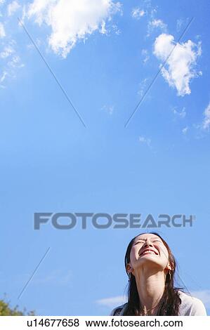 Young Woman Looking Up the Sky View Large Photo Image Stock Photo - Young Woman Looking Up the Sky. Fotosearch