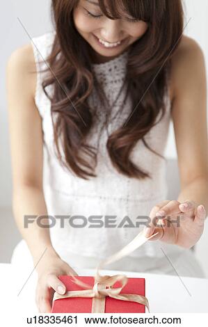 Young woman opening present box, white background View Large Photo Image Stock Image - Young woman opening present box, white background. Fotosearch