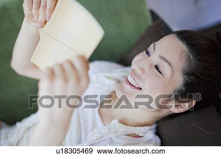 Stock Photo - Young Woman Reading Book. Fotosearch