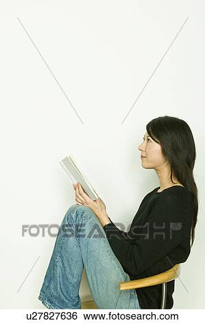 Stock Photograph - Young Woman Reading Book. Fotosearch