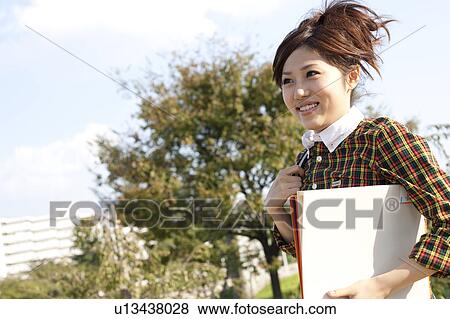 Stock Photo - Young woman running, Japan. Fotosearch