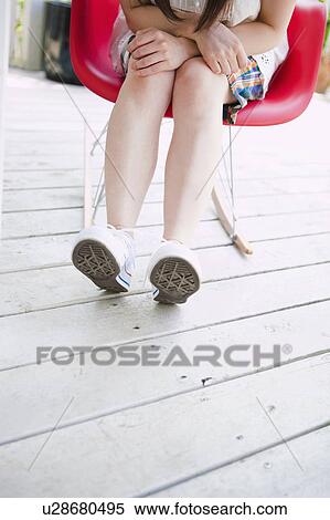Young Woman Sitting on Chair, Low Section View Large Photo Image Stock Photography - Young Woman Sitting on Chair, Low Section. Fotosearch