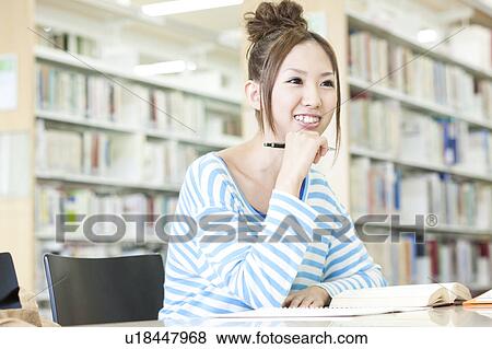 Young woman studying in a library, Japan View Large Photo Image Stock Photo - Young woman studying in a library, Japan. Fotosearch