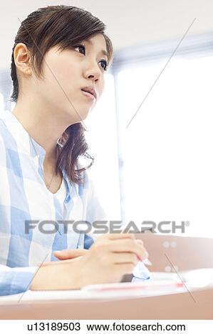 Young woman studying in classroom, Japan View Large Photo Image Stock Image - Young woman studying in classroom, Japan. Fotosearch