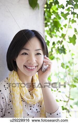 Stock Photograph - Young Woman Talking on Phone. Fotosearch