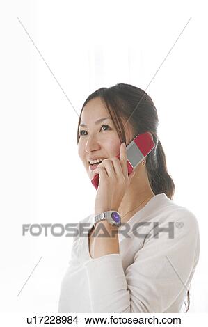 Picture - Young Woman Talking on the Cellular Phone. Fotosearch