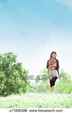 Young woman walking at a park, Japan View Large Photo Image Stock Photo - Young woman walking at a park, Japan. Fotosearch