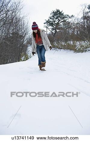 Young Woman Walking in Snow View Large Photo Image Stock Photo - Young Woman Walking in Snow. Fotosearch