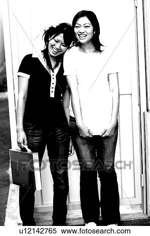 Stock Photography - Young women standing and smiling. Fotosearch