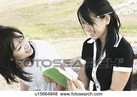 Stock Photo - Young women studying outdoors. Fotosearch
