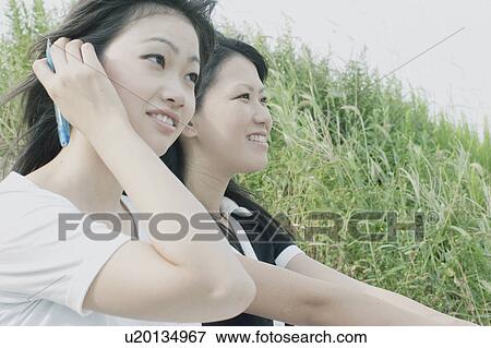 Stock Photo - Young women studying outdoors. Fotosearch