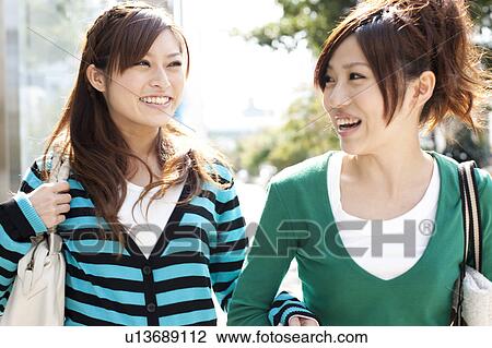 Stock Image - Young women window shopping, Japan. Fotosearch