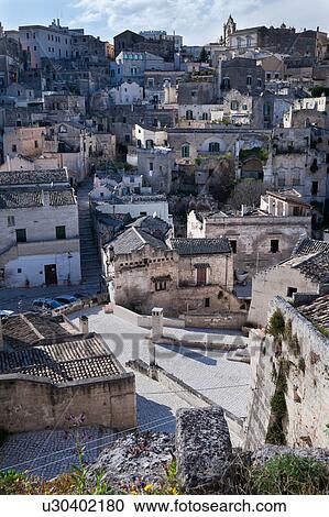 Stock Image - Aerial detail of ancient town of Matera with tufa houses, sunny spring afternoon, Puglia, Southern Italy,. Fotosearch